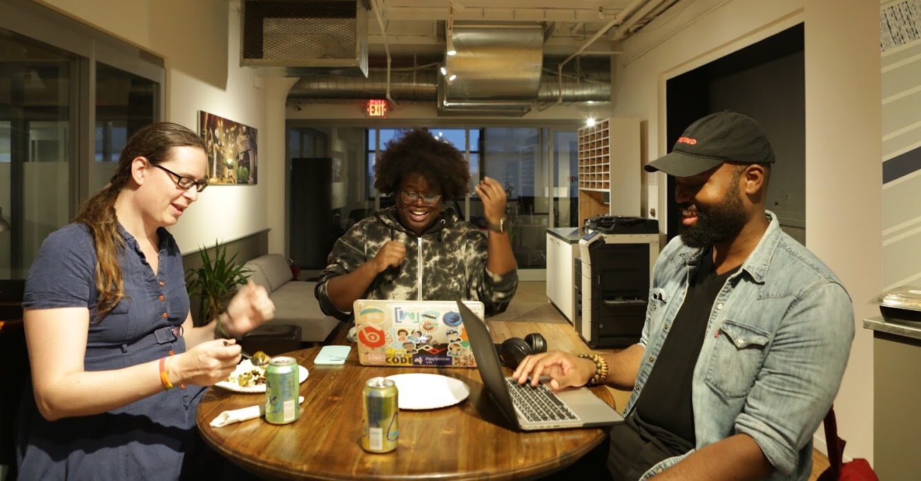 A photo of three people sat with their laptops, taken at a codebar NYC workshop